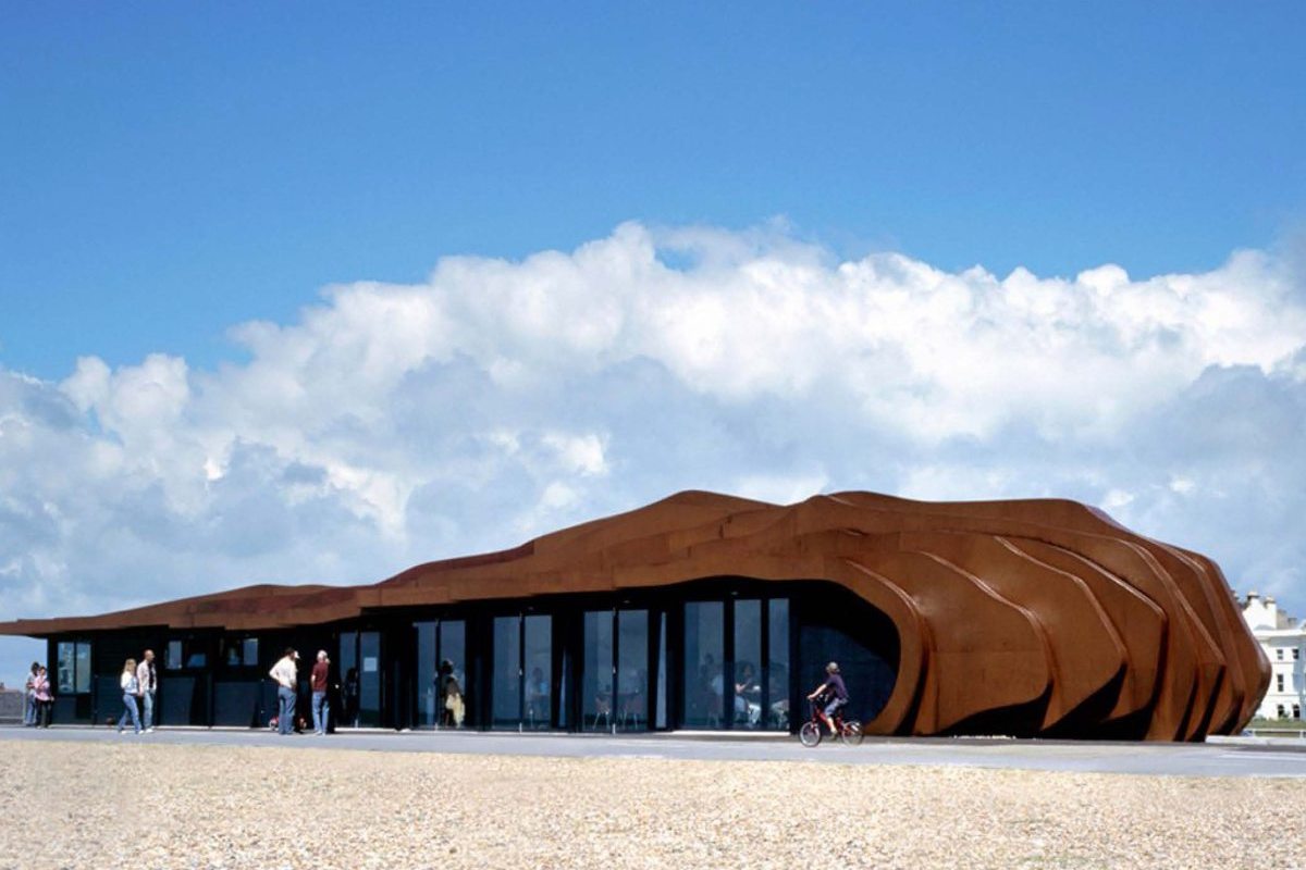 A low café with a rippled weathering-steel shell on the shingle at Littlehampton beach